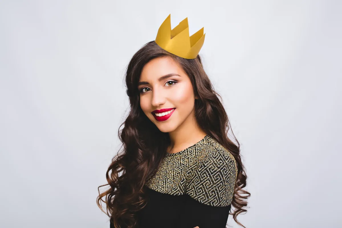 Smiling woman wearing a paper crown