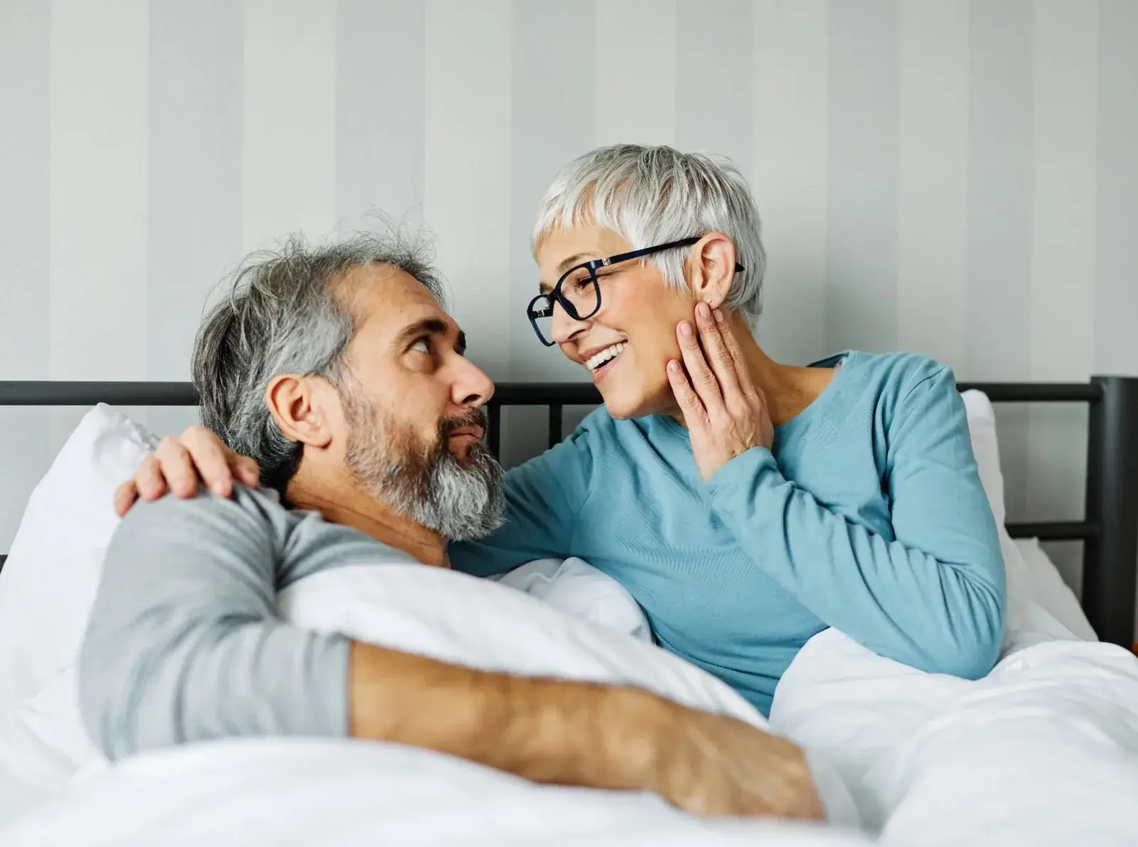 A menopausal woman enjoying an intimate moment with her husband.