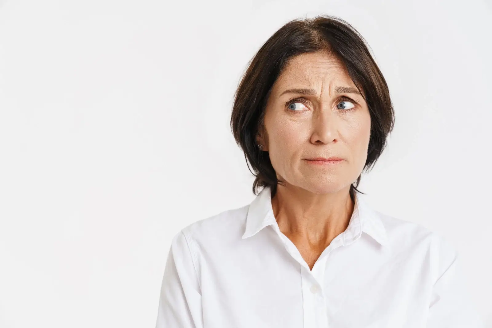 Worried mature woman frowning, wondering is bleeding after menopause always cancer.
