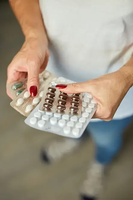 mature woman hold in hand blister pack of pills 2025 01 09 01 56 32 utc 1