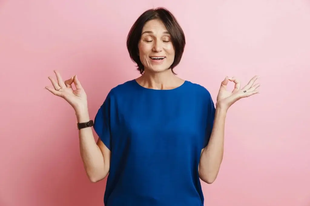 Midlife woman practicing calm meditation, symbolizing hormonal and gut balance during menopause.