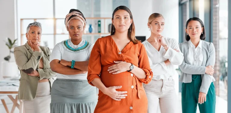 Diverse group of women across life stages including pregnancy, perimenopause, and menopause standing confidently together, representing hormonal health and estrogen changes in women.