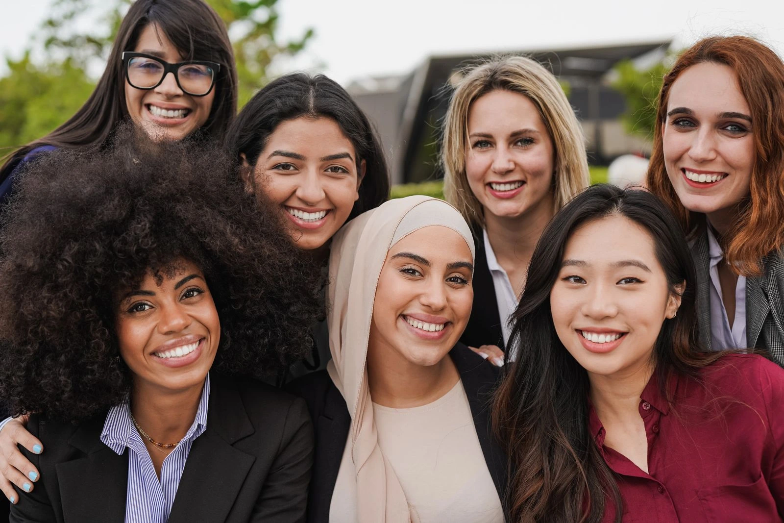 Diverse group of women smiling together, representing hormonal health, estradiol balance, and women’s wellbeing across different life stages