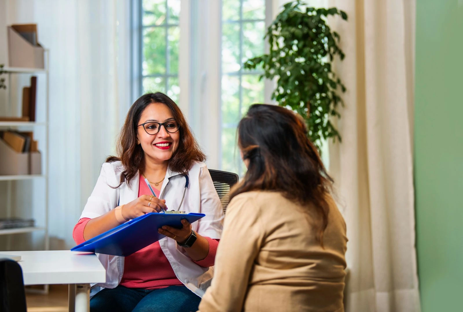 Female gynecologist consulting a midlife woman during a women’s health appointment, discussing hormone balance, estradiol therapy, and menopause care in a clinical setting