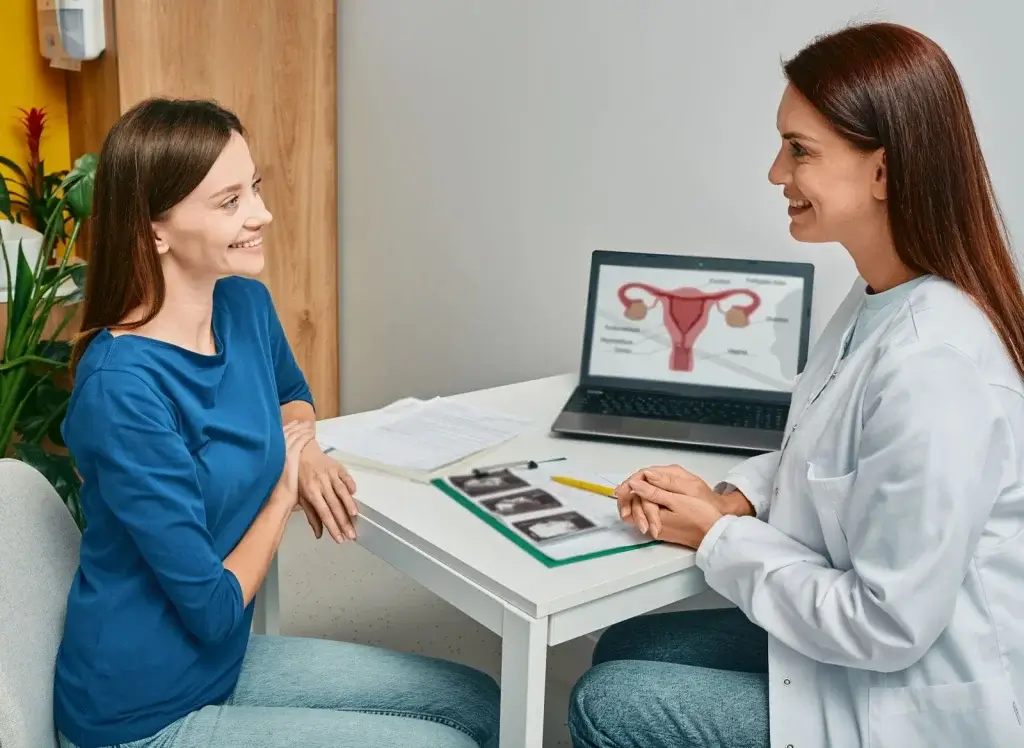 Woman consulting an OB-GYN about menopause and hormone therapy, discussing HRT vs MHT options during midlife.