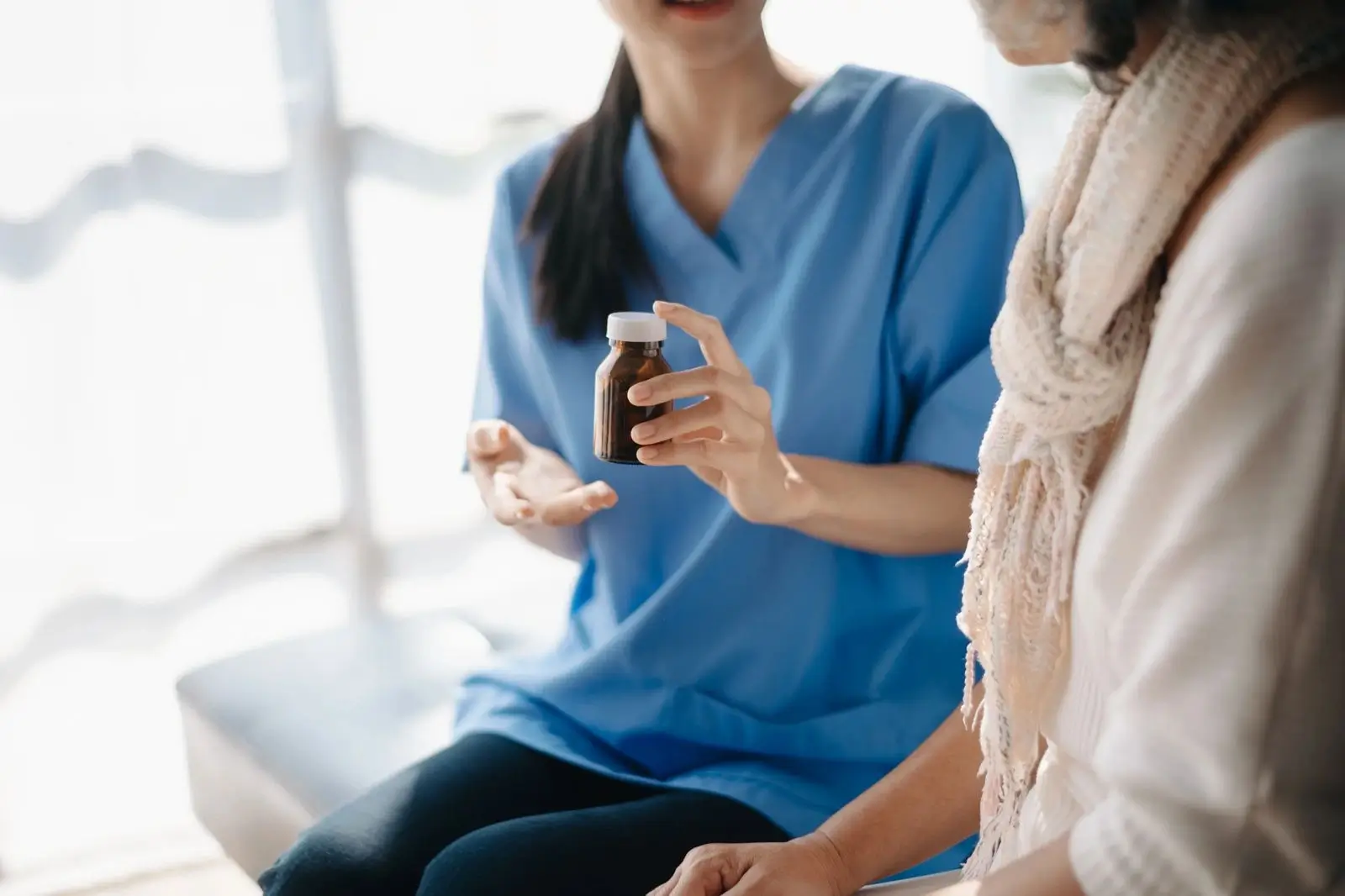 Healthcare professional discussing menopause treatment options with a woman, explaining medical and natural approaches for symptom management.