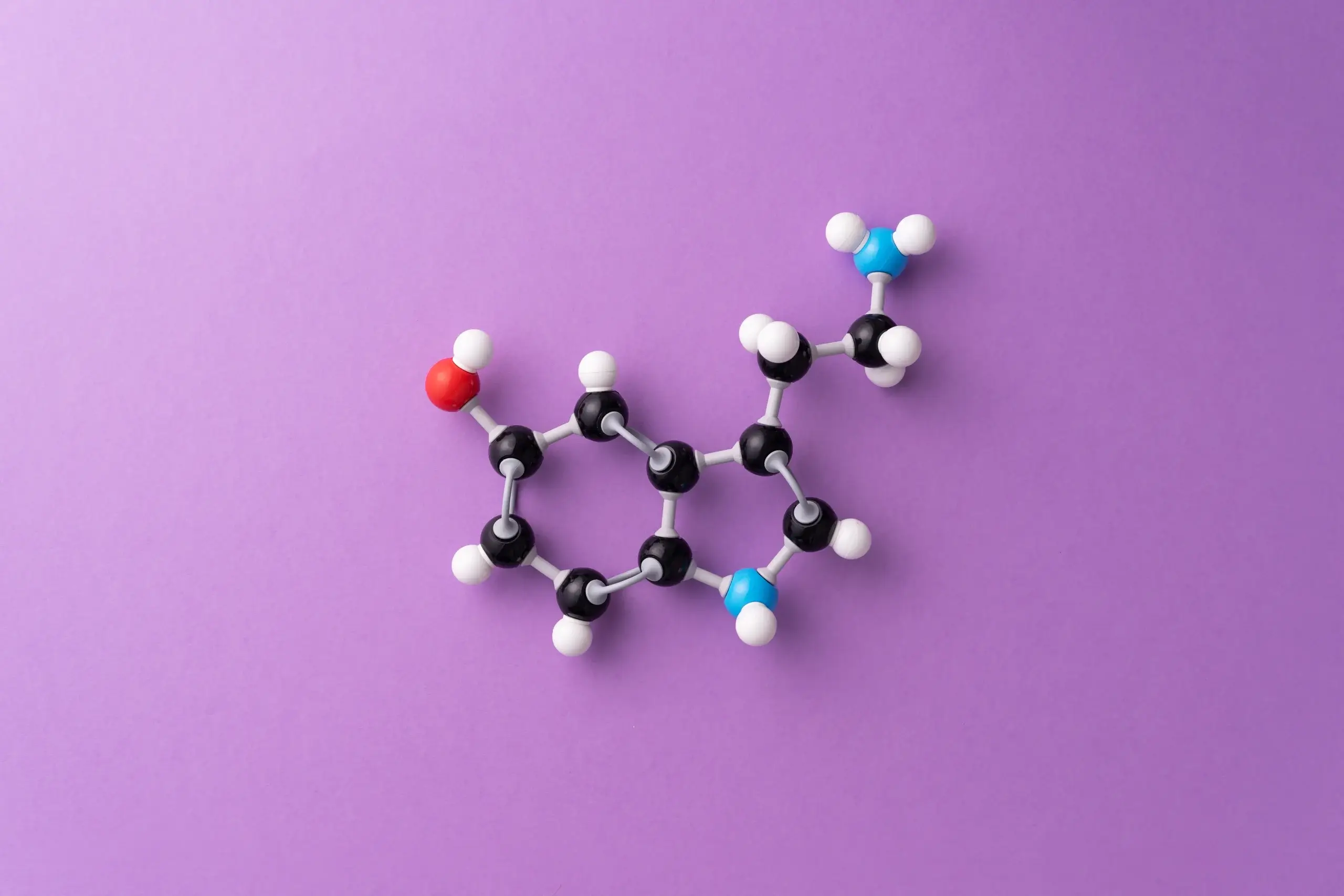 Progesterone hormone chemical proposition on a plain purple background
