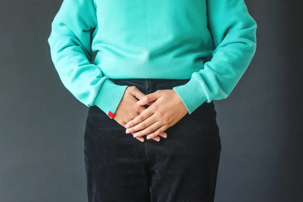 Vaginal dryness menopause woman in blue sweater showing problem area