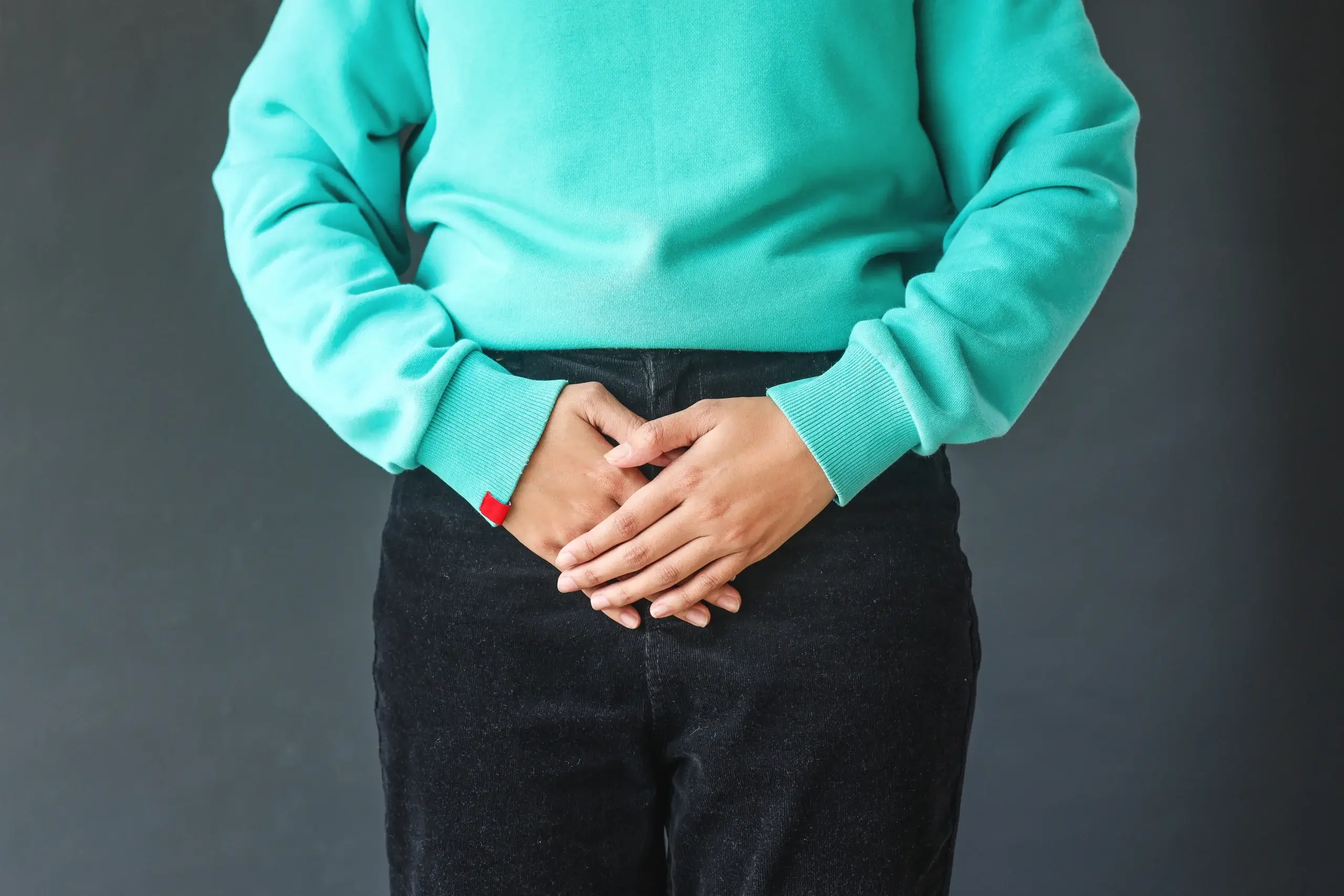 Vaginal dryness menopause woman in blue sweater showing problem area