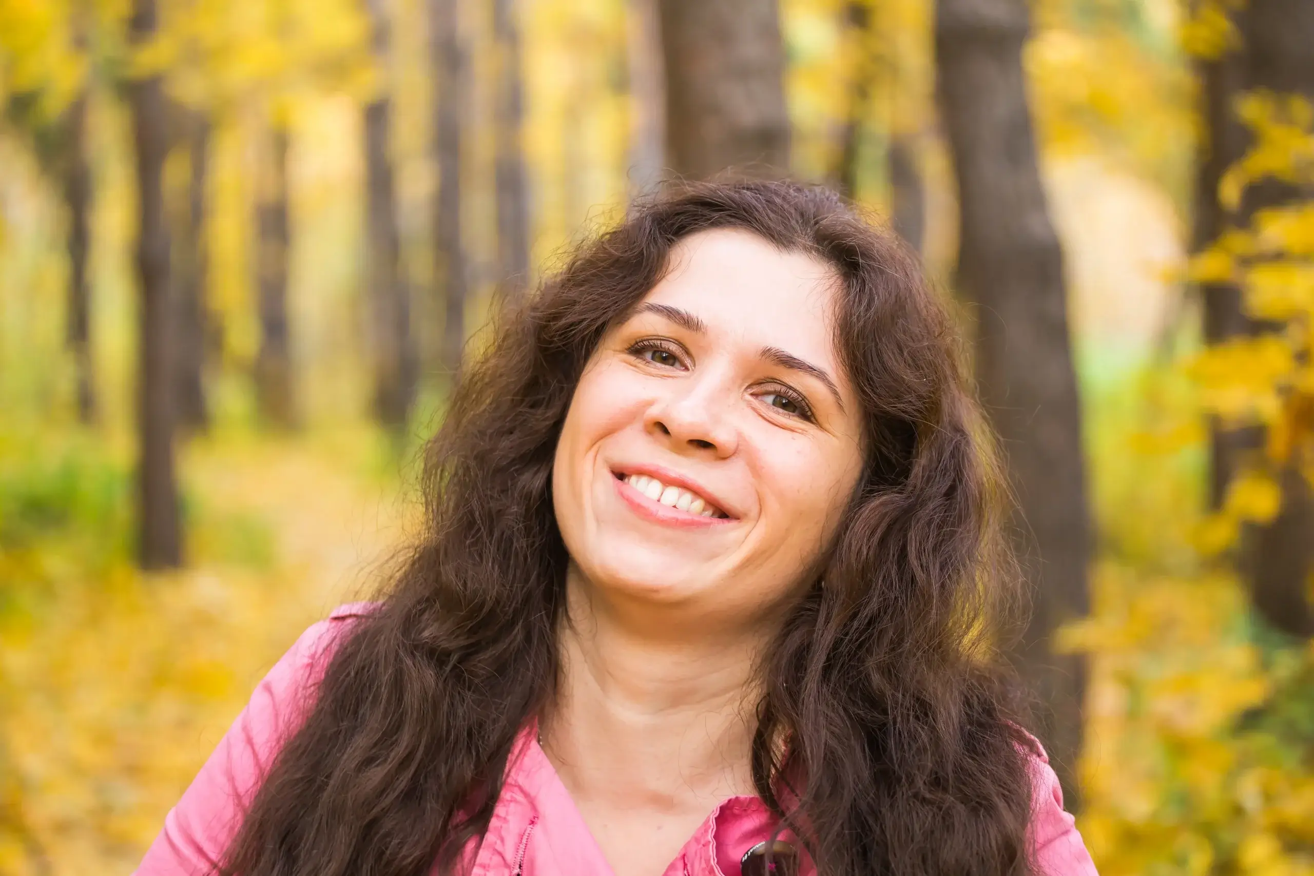 Woman smiling outdoors during perimenopause wellness journey to naturally support dopamine and mood
