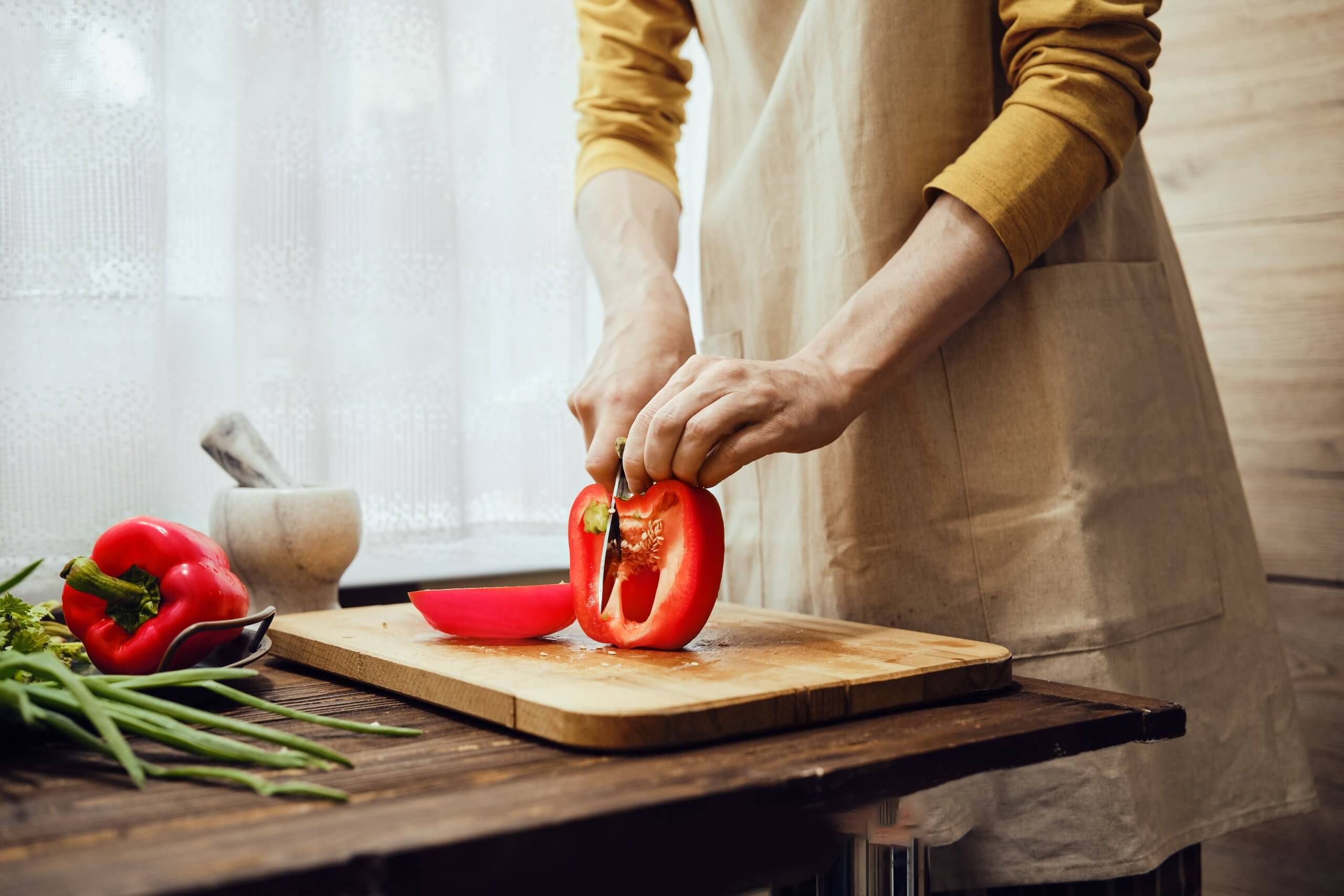Woman preparing fresh vegetables to support hormonal health and manage menopause symptoms through nutrition