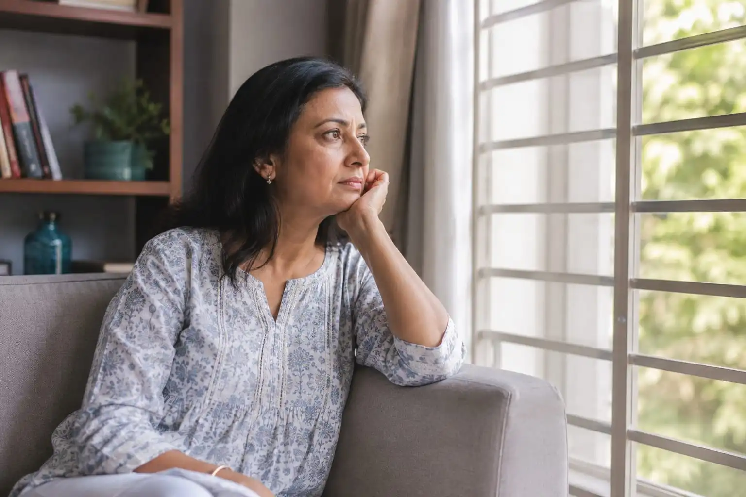 Indian woman in her late 40s reflecting during menopause transition, highlighting menopause age in India and healthy ageing