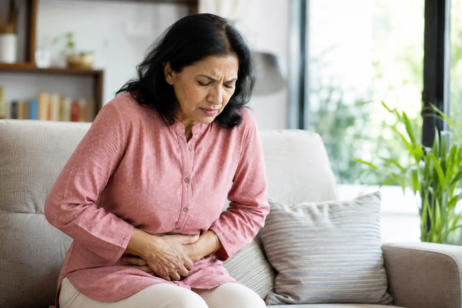Indian woman experiencing ovulation pain after menopause and lower abdominal discomfort