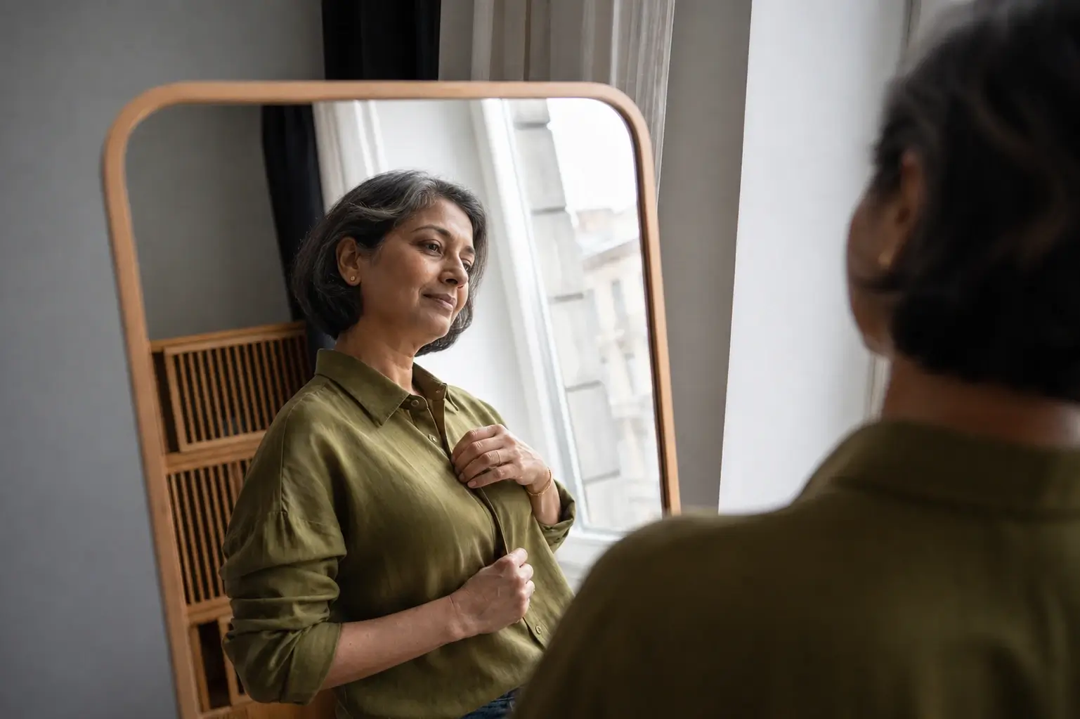 Self-esteem in menopause: Indian woman reflecting on her confidence and changing self-image.