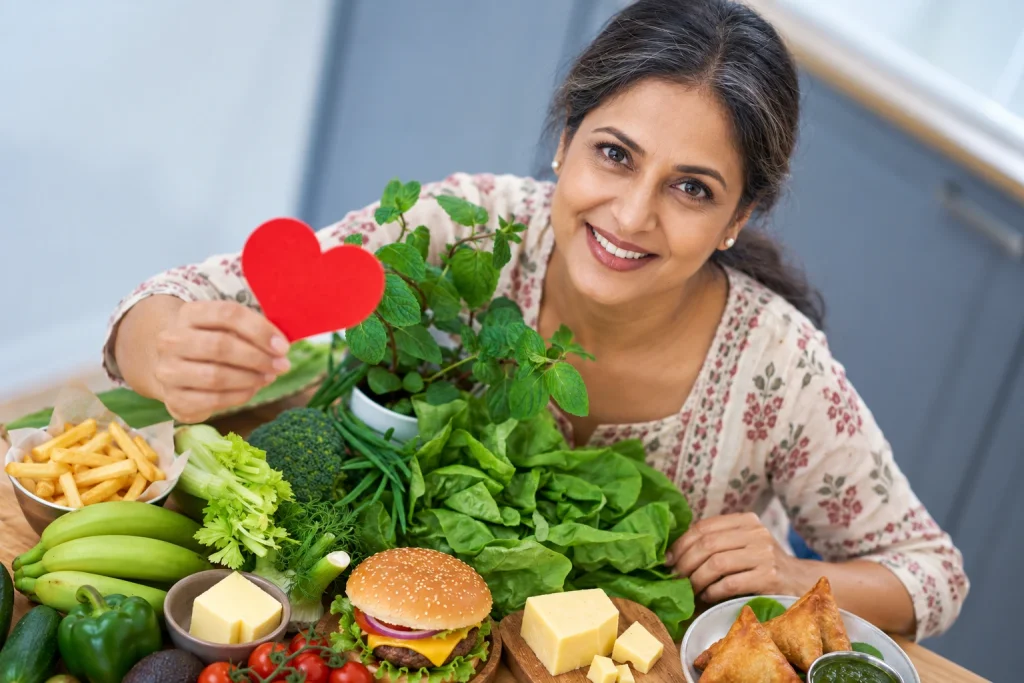 Indian woman in her 40s reviewing heart-healthy and high-cholesterol foods during menopause.