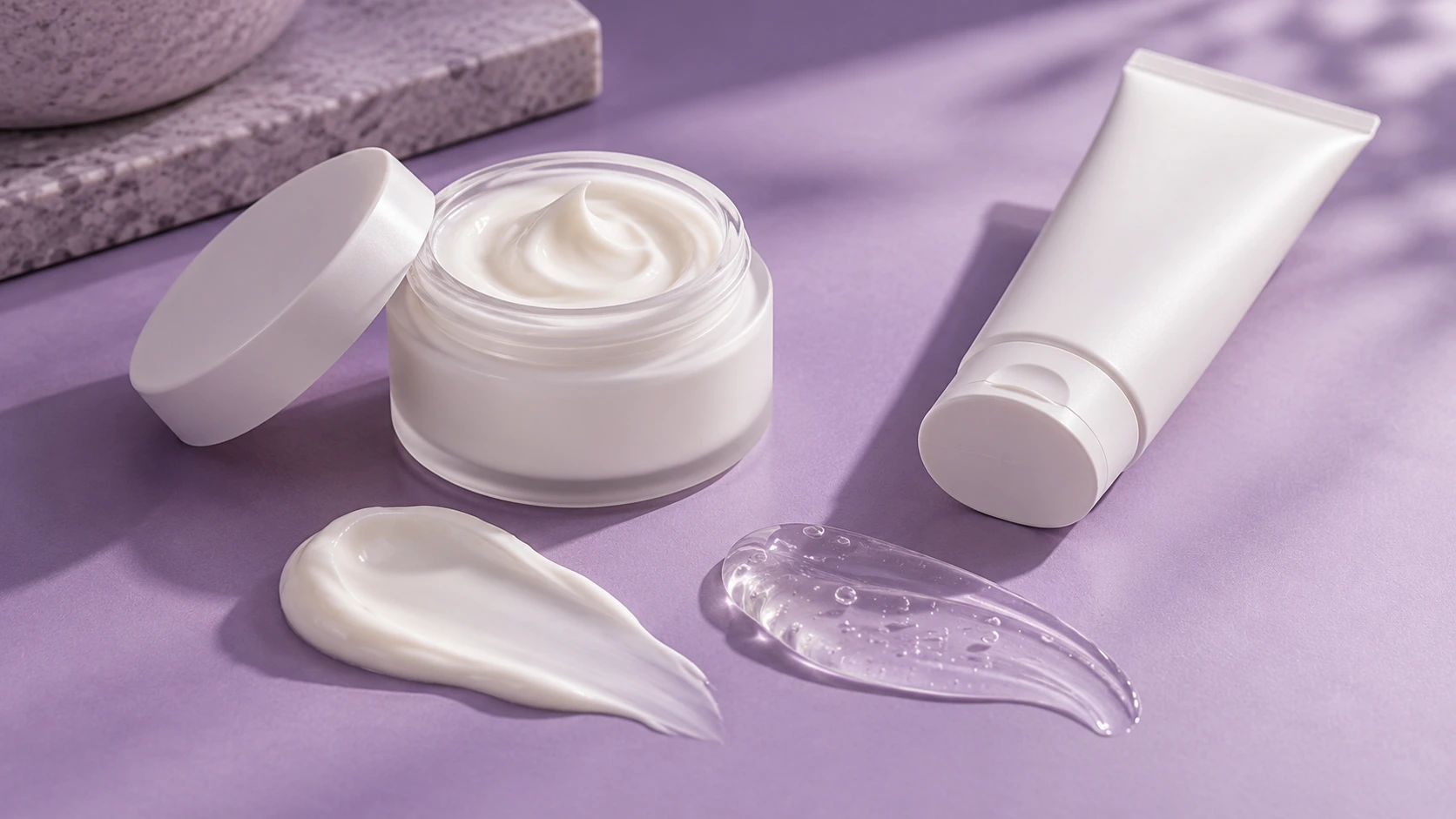 Vaginal dryness cream and clear gel displayed on a purple background, illustrating different moisturising formulations